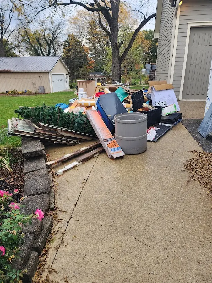 Dumpster being loaded with debris for Residential Dumpster Rental in Spirit Lake